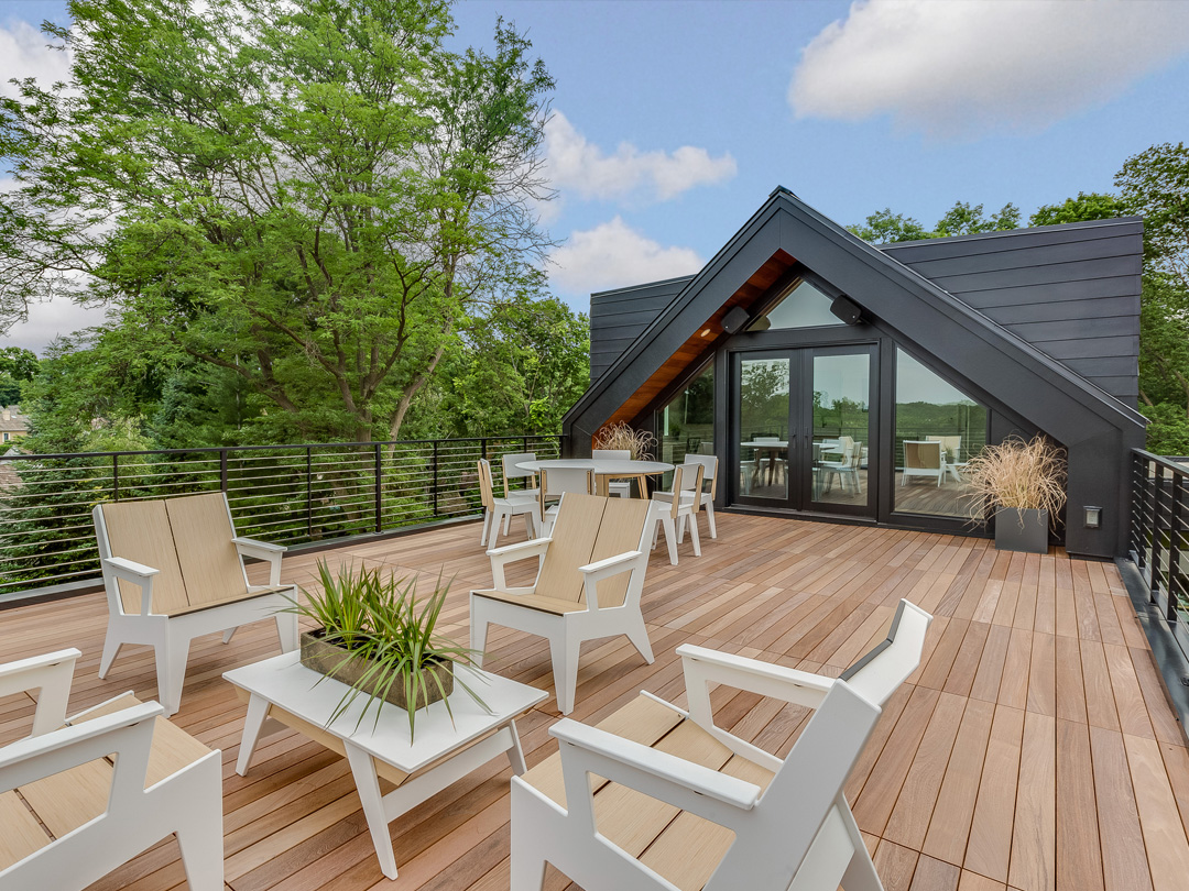 large deck with white and tan patio furniture