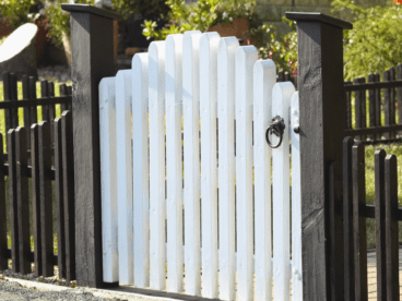 dark brown wood fence with white wood gate