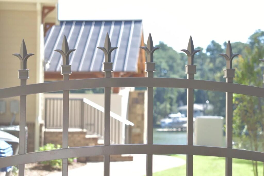 A close up shot of an ornamental aluminum fence with pointed tips.