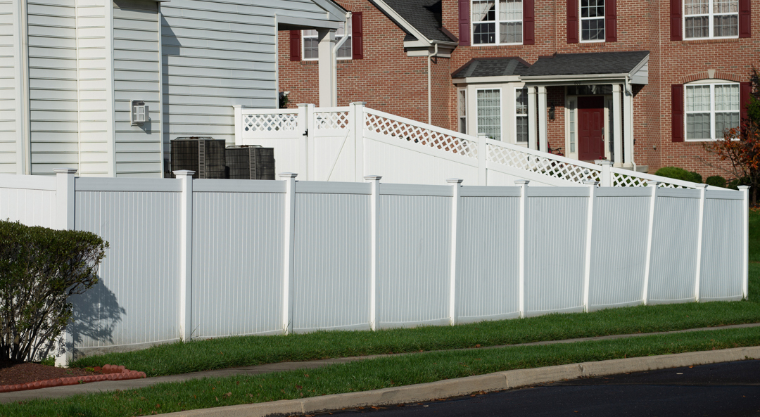White vinyl fence in residential neighborhood home.