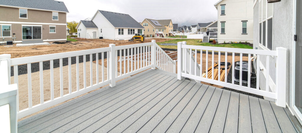 Deck with stairs going down to the yard of home overlooking the neighborhood.