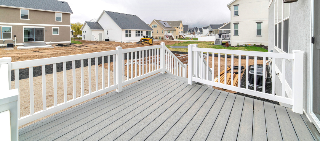 Deck with stairs going down to the yard of home overlooking the neighborhood.