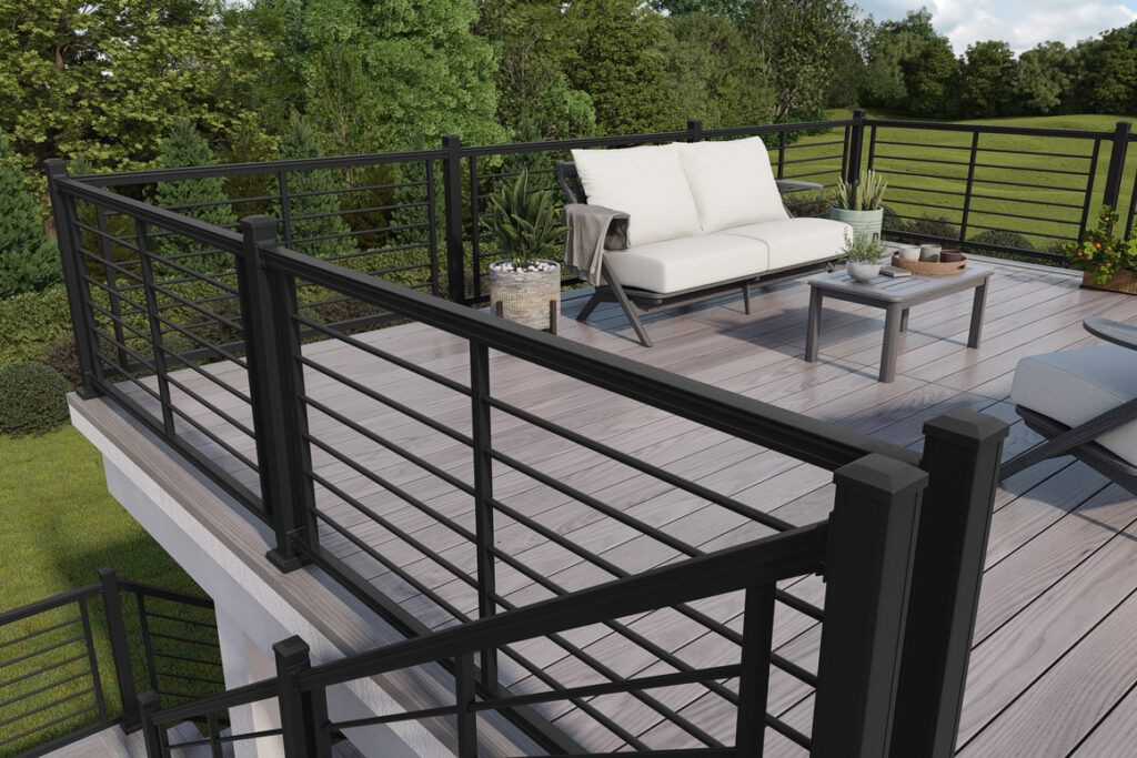 A modern looking back deck featuring gray decking and black rod deck railing.