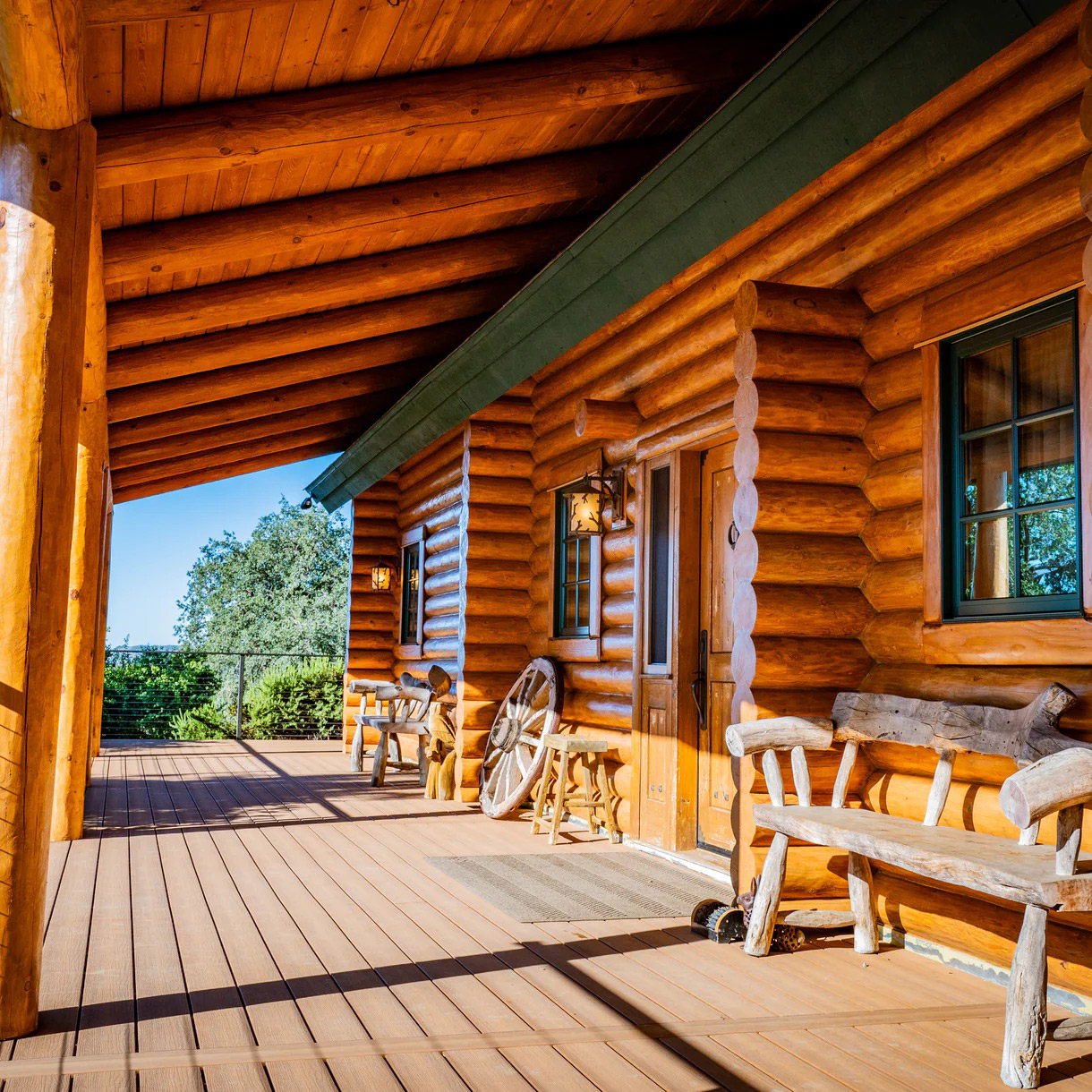 On a front porch at a log cabin, all the features are boldly lumber.
