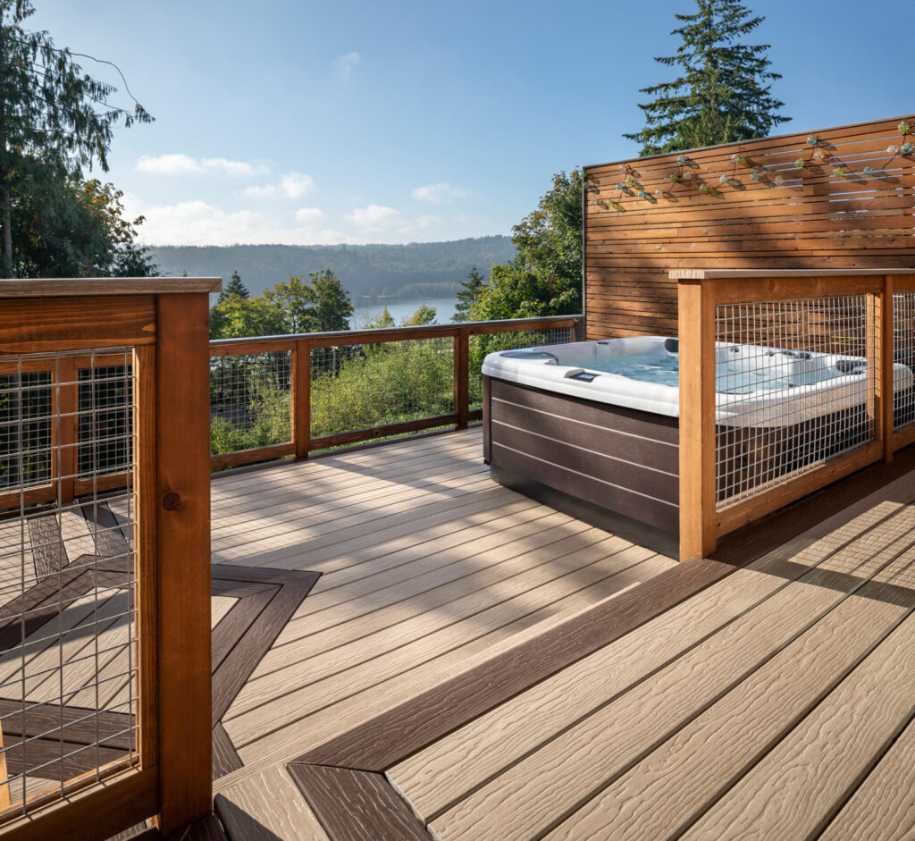 Staring out down to a lake from a deck on the side of a mountain.