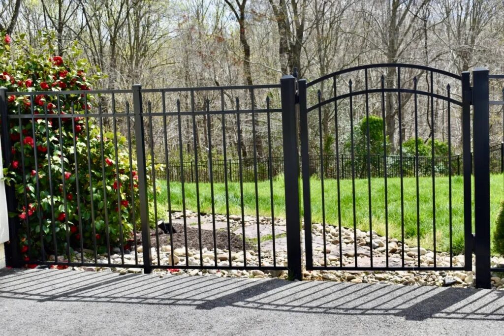 A black painted aluminum ornamental fence and gate.