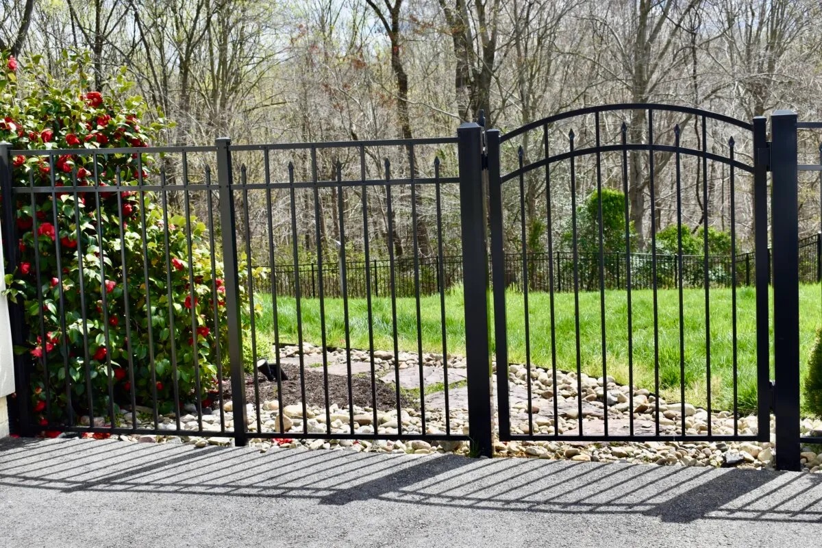 A black painted aluminum ornamental fence and gate.