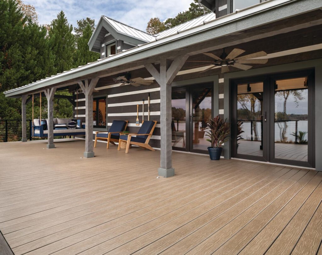 Looking at a side patio of a beautifully designed lake house.