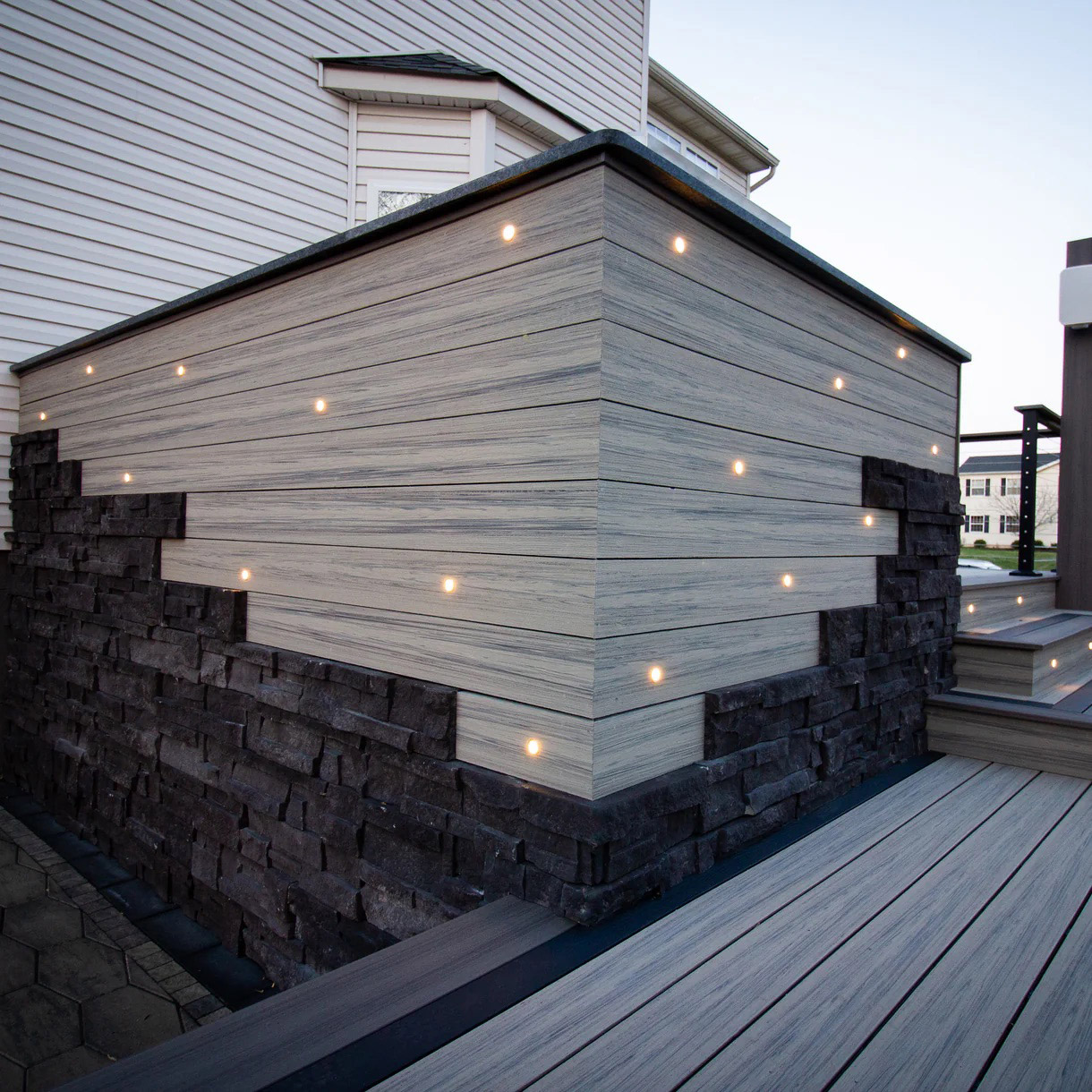 Looking at a modern designed deck corner featuring built in lights.