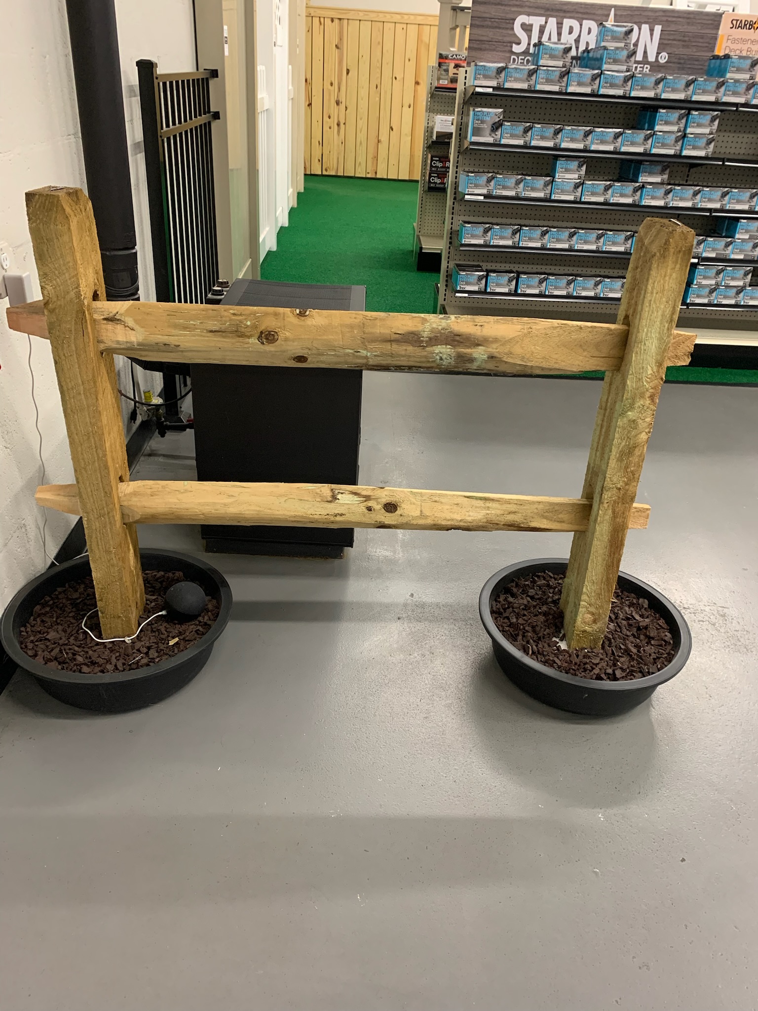A smaller, in store sample display of a lumber post fence.