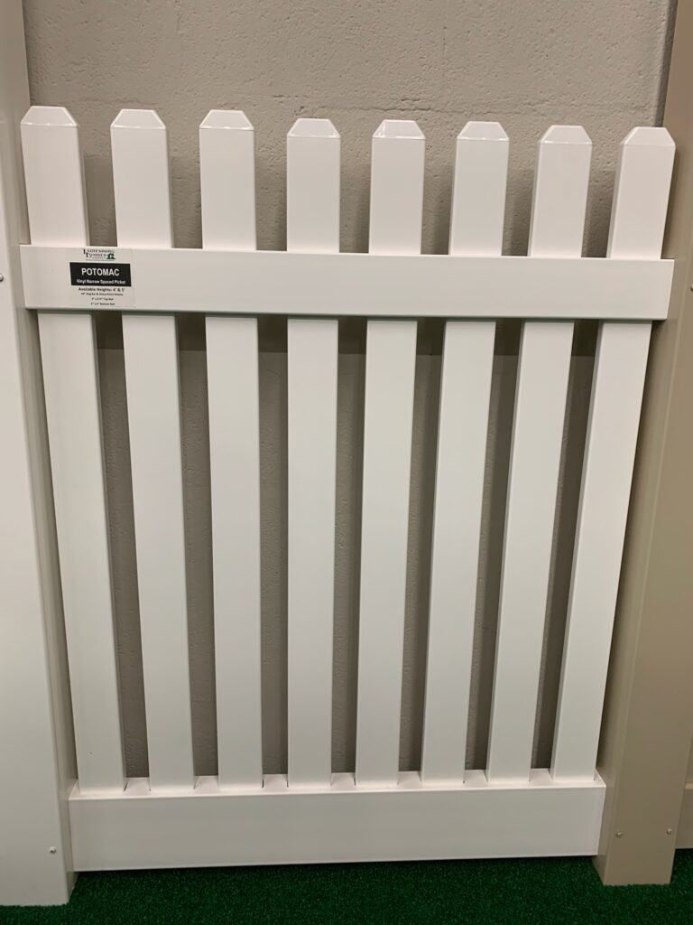 A vinyl white picket fence sample on display at Ladiesburg Lumber.