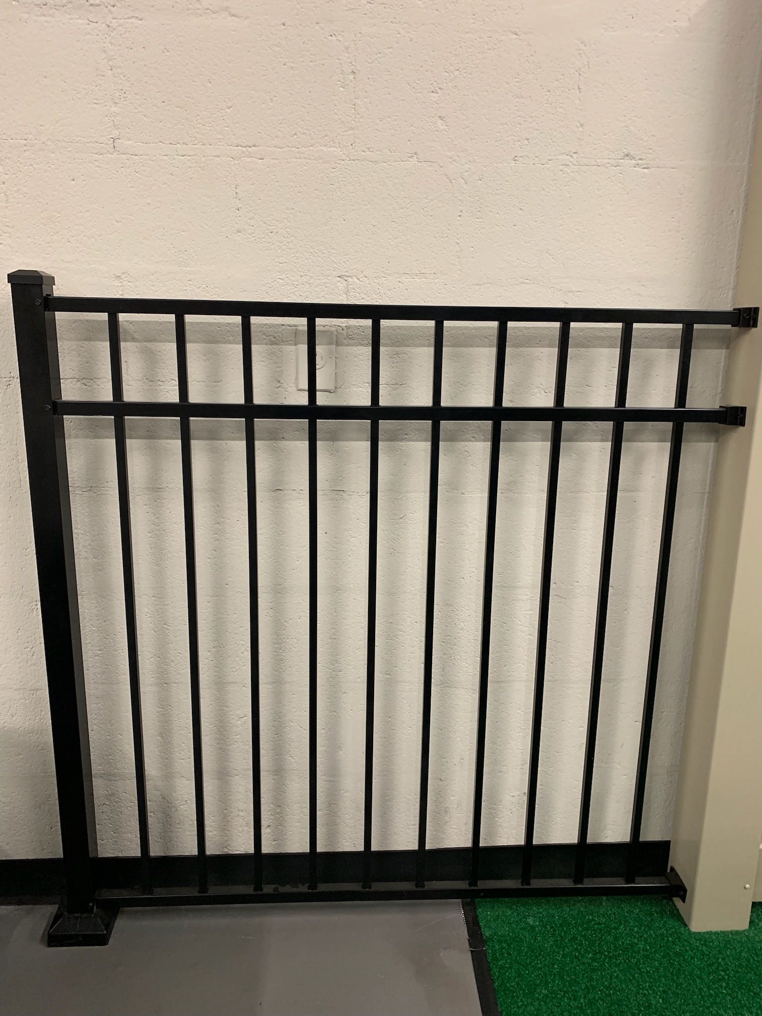 An aluminum fence sample painted black on display inside Ladiesburg Lumber.