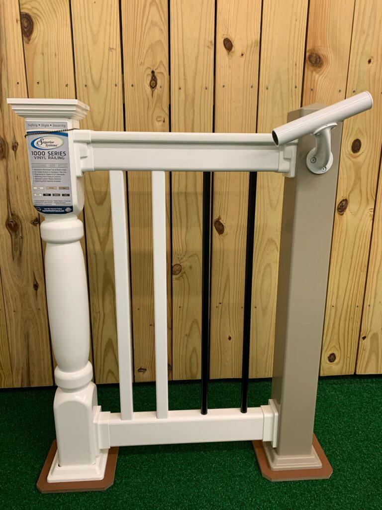 A white, composite fence sample for a deck featuring a railing for easy stair stepping.