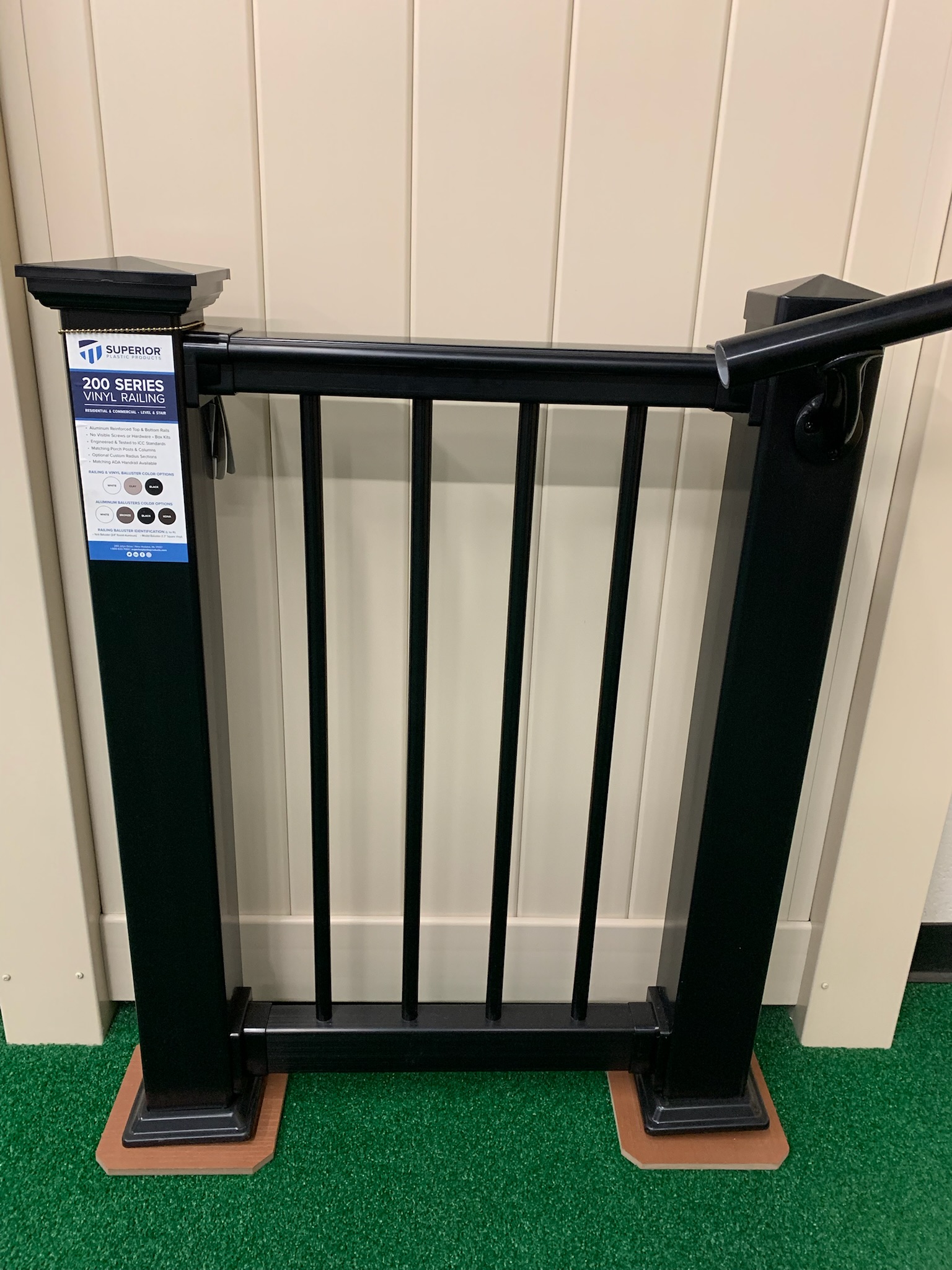 A store sample of a black, composite deck fence.