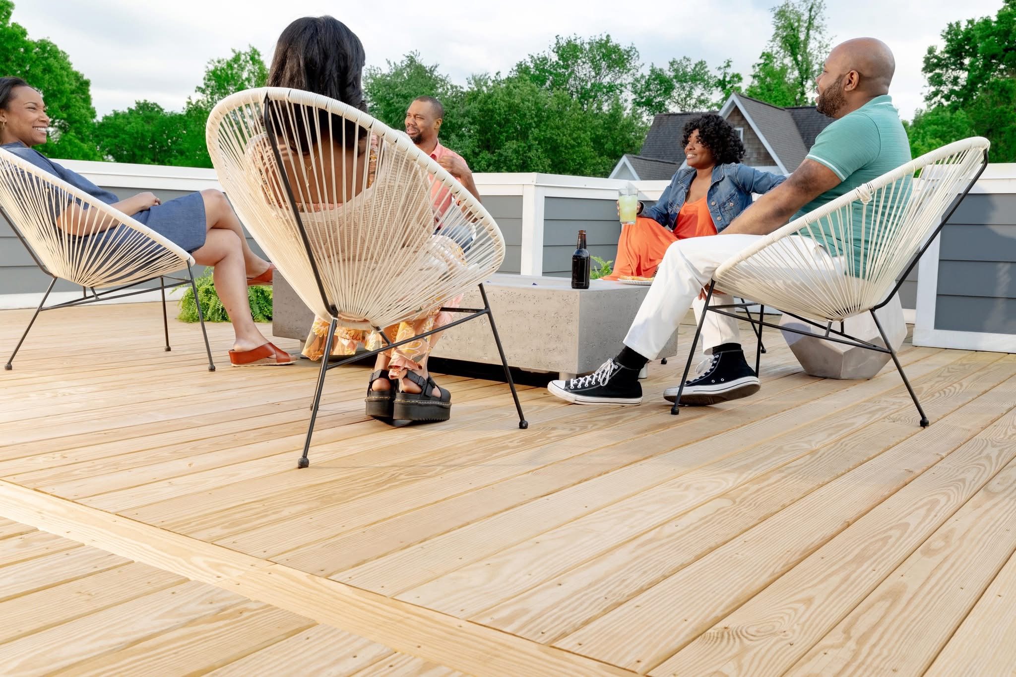 Friends and family enjoying their newly built deck supplied by Ladiesburg Lumber.