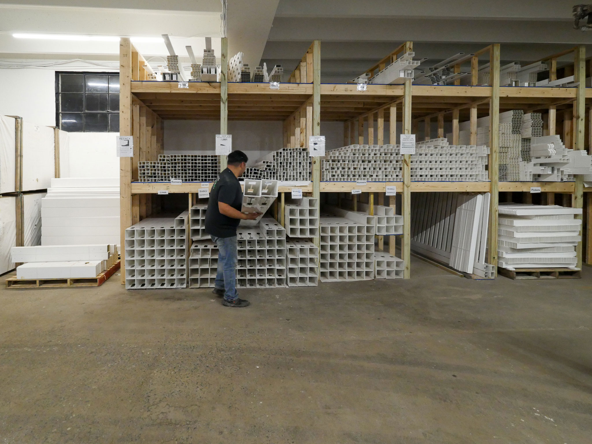 The back storage area inside Ladiesburg Lumber where decking and fencing supplies are kept in bulk.