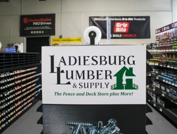 Inside the Ladiesburg Lumber store, looking a the aisle end with a store graphic posted up.