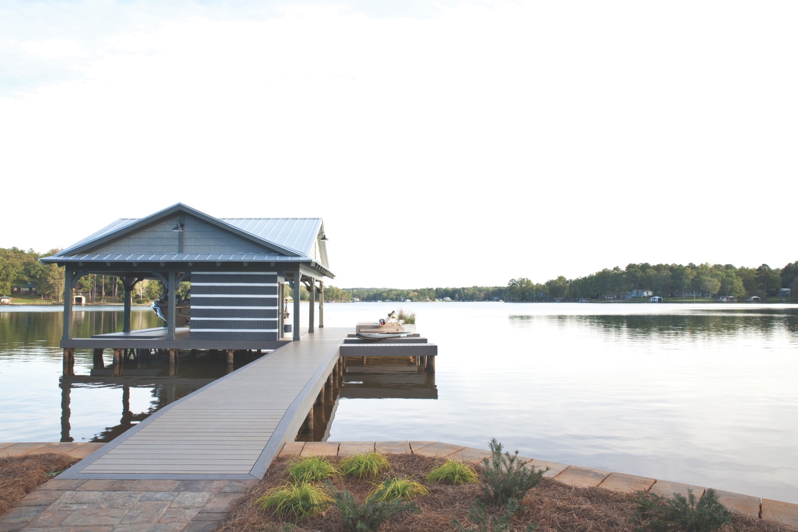 Looking out onto a lake, there is a small docking area with an overhang.