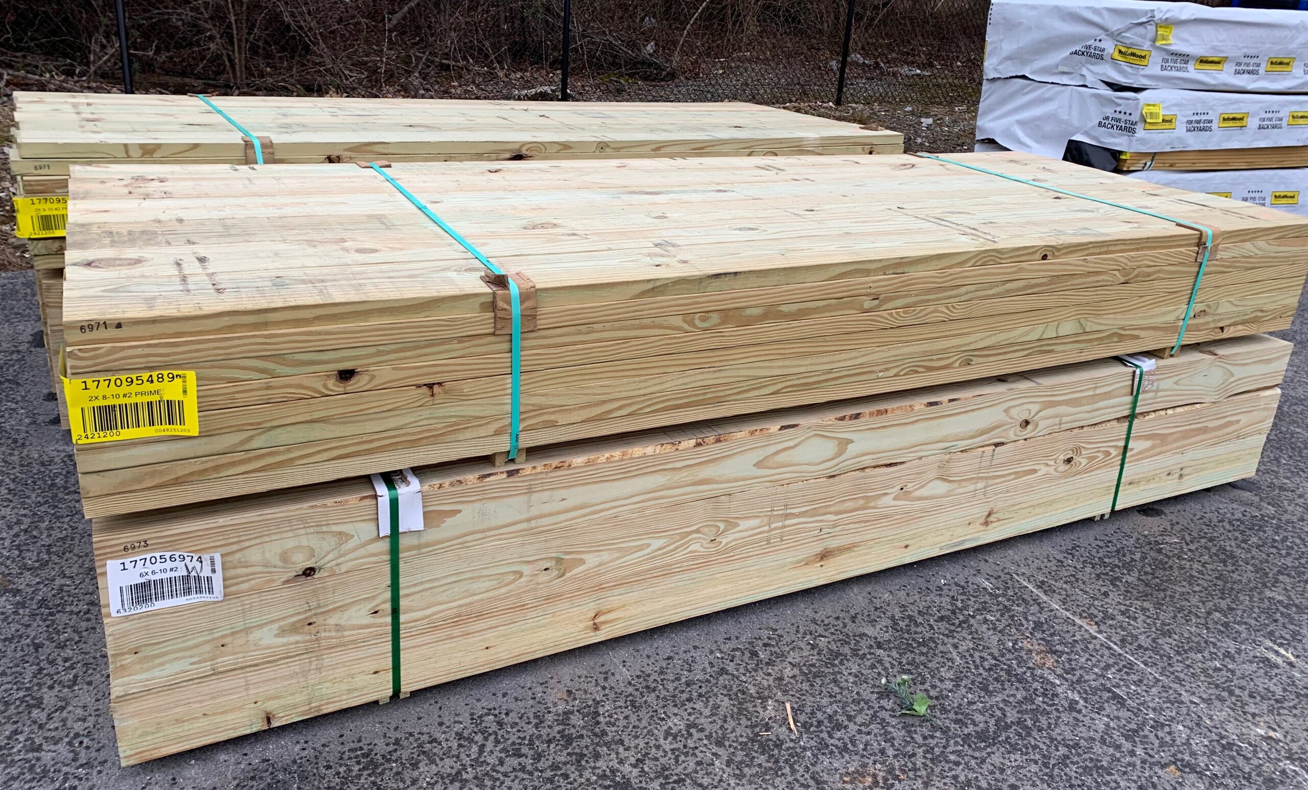 Stacks of 6x6 posts and 2x8 boards sitting in the Ladiesburg Lumber parking lot.