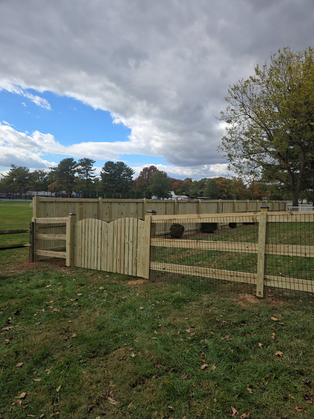A custom designed and supplied wooden fence (with chicken wire) by Ladiesburg Lumber.