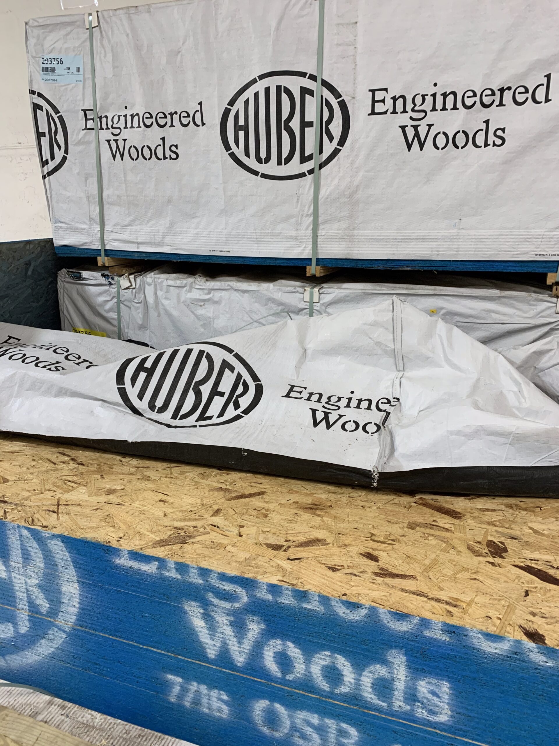 A close up shot of a stack of Huber plywood at Ladiesburg Lumber.