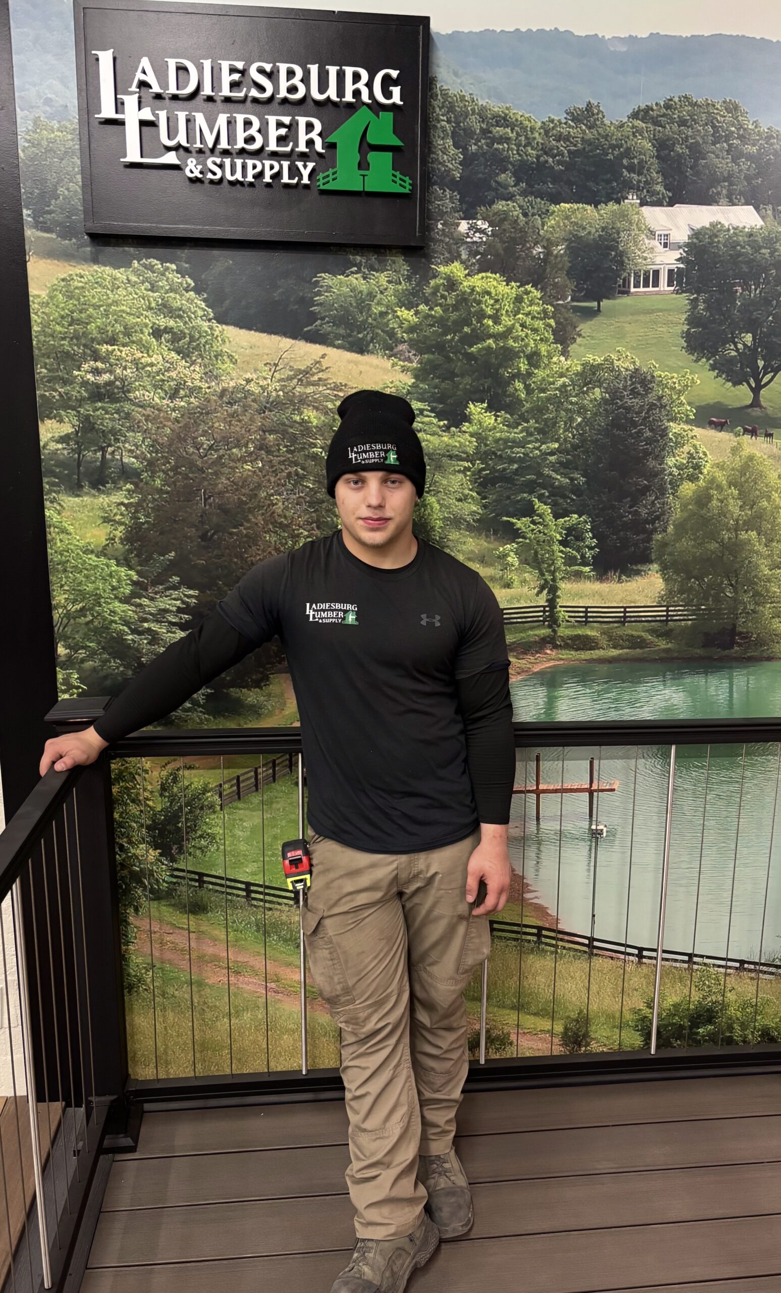 Dominic Smitley (Lumberyard) standing in front of an in store graphic.