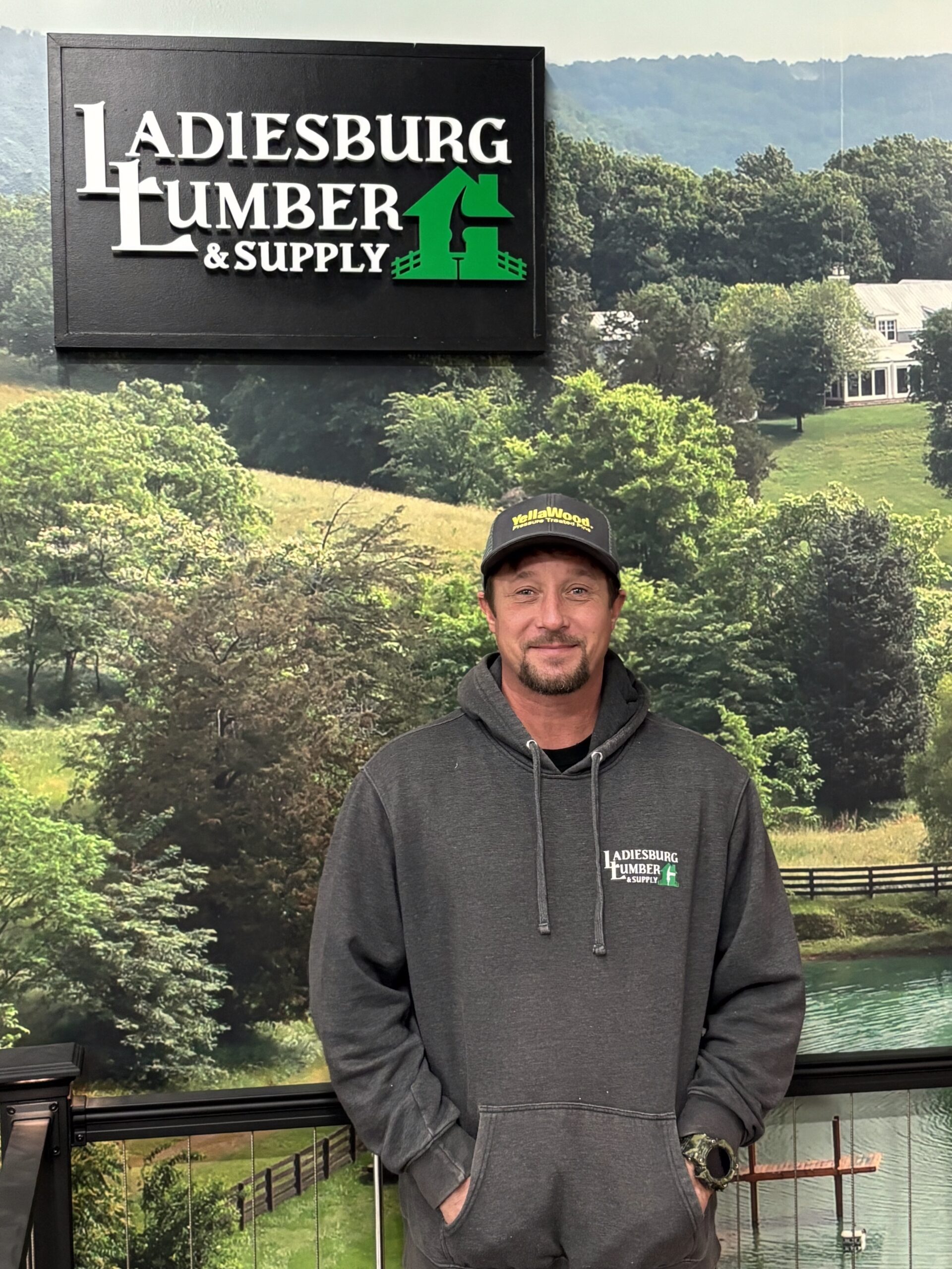 Scott Sweeney (Lumberyard) standing in front of an in store graphic.